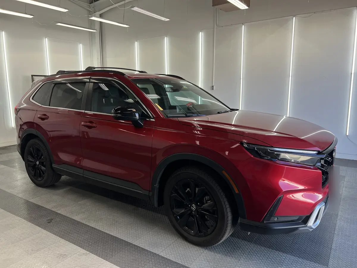 Red Honda CR-V before window tinting, factory glass (view 2)