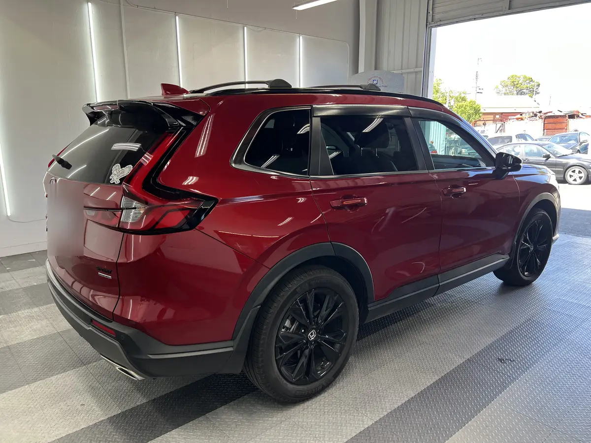 Red Honda CR-V before window tinting, factory glass (view 3)