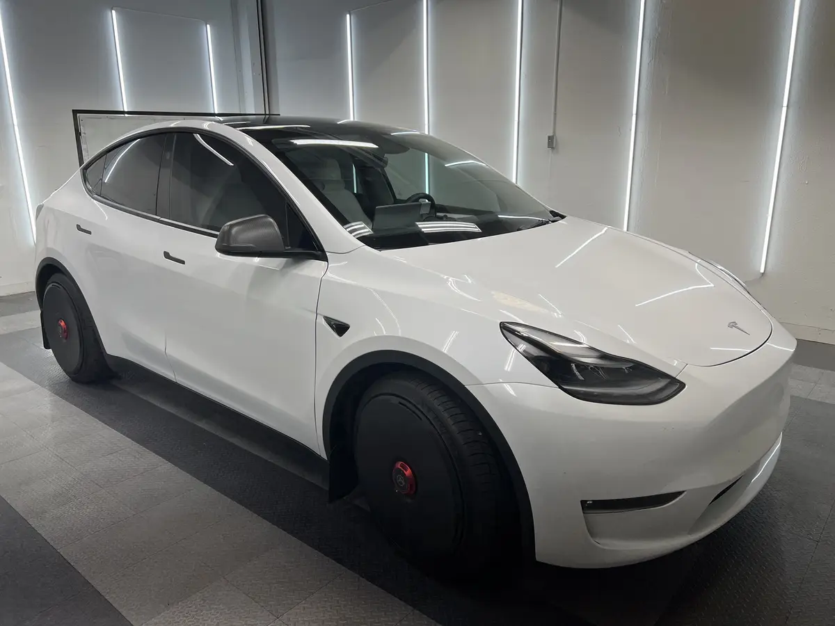 White Tesla Model Y before window tinting, factory glass (view 1)