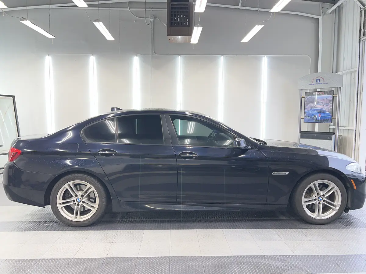 Blue BMW 5 Series after Avery Dennison Encore Supreme ceramic window tint (view 1)