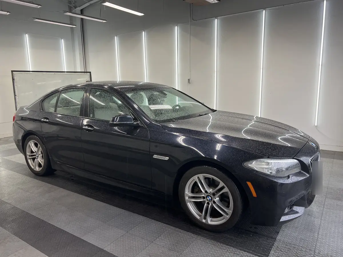 Blue BMW 5 Series before window tinting, factory glass (view 3)
