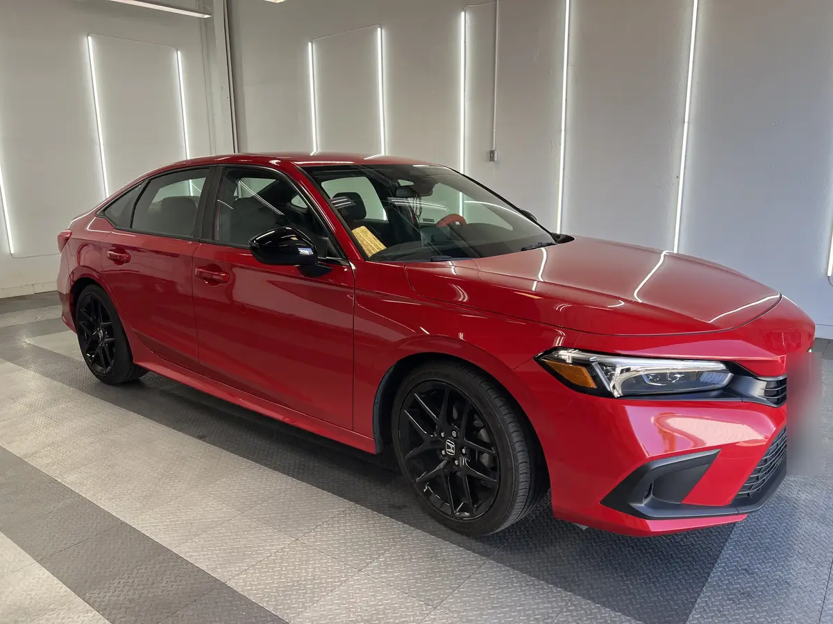 Red Honda Civic before window tinting, factory glass (view 1)