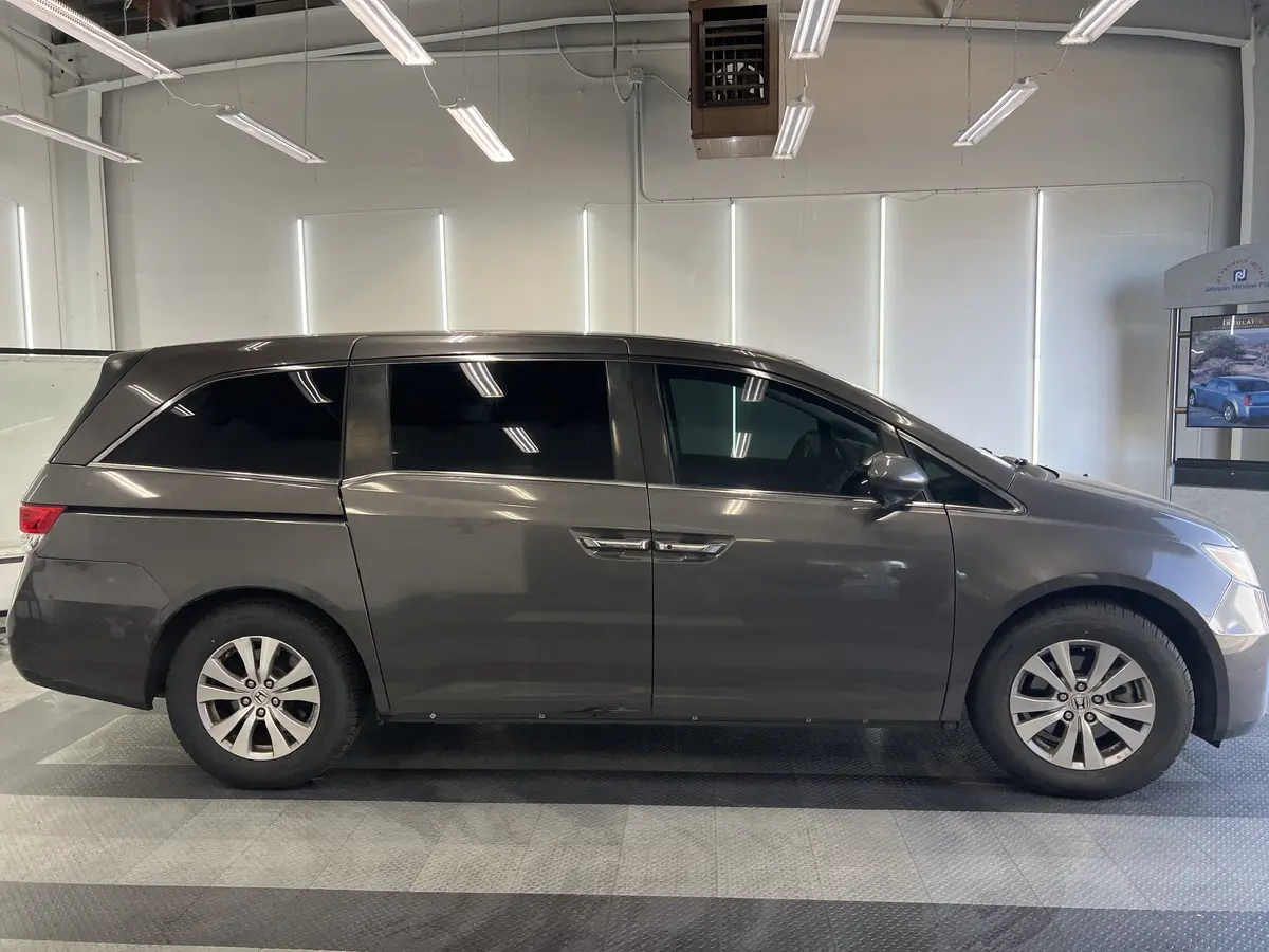 Gray Honda Odyssey after Avery Dennison Encore carbon window tint (view 2)