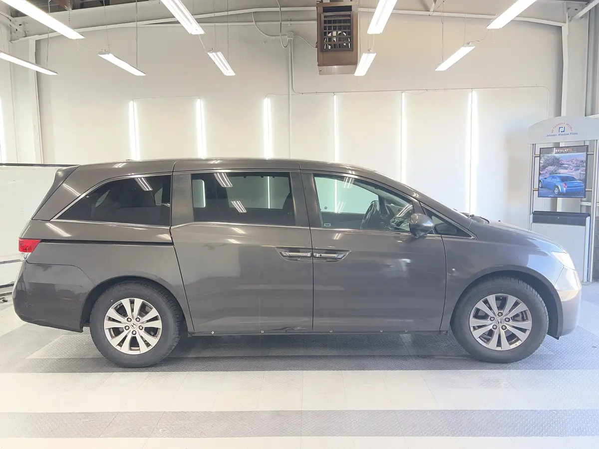 Gray Honda Odyssey before window tinting, factory glass (view 2)