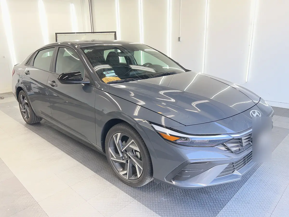 Gray Hyundai Elantra before window tinting, factory glass (view 1)