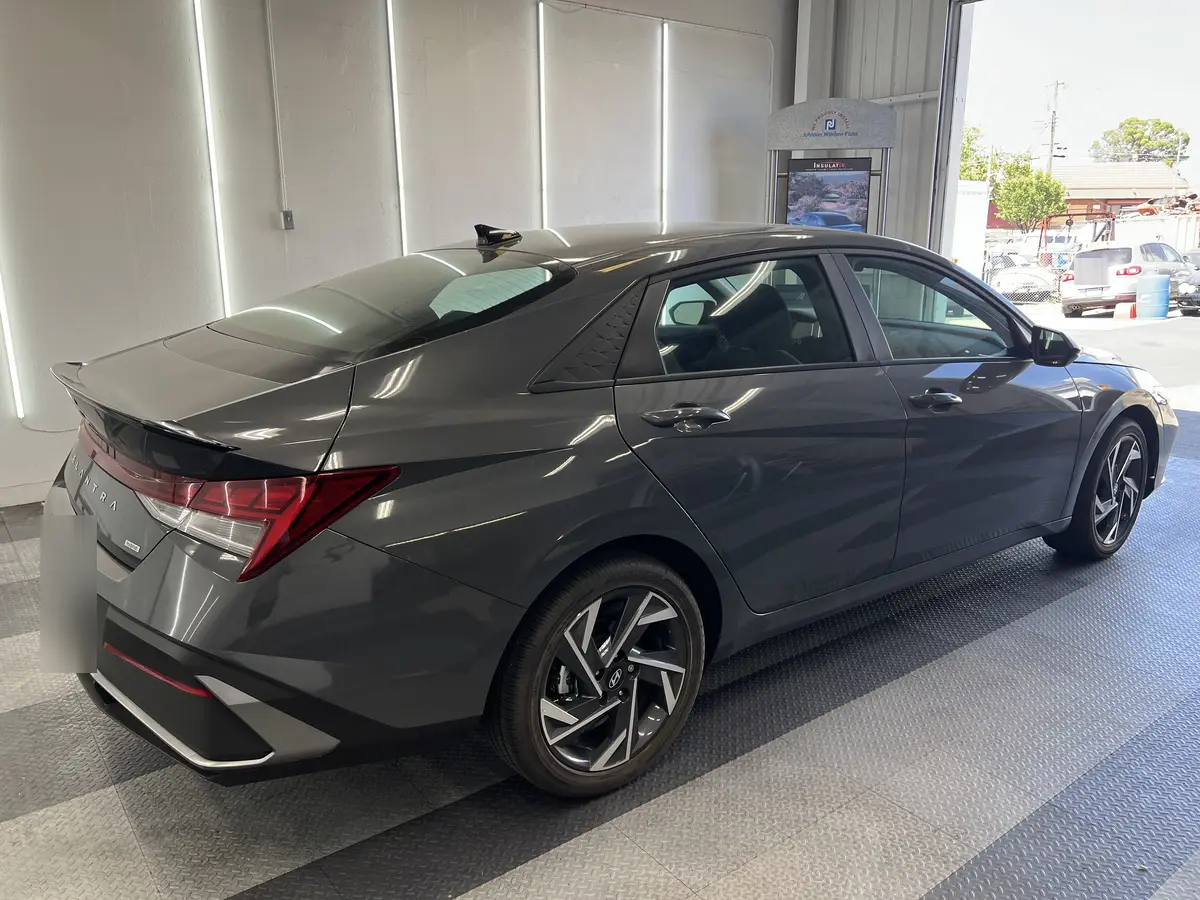 Gray Hyundai Elantra before window tinting, factory glass (view 2)