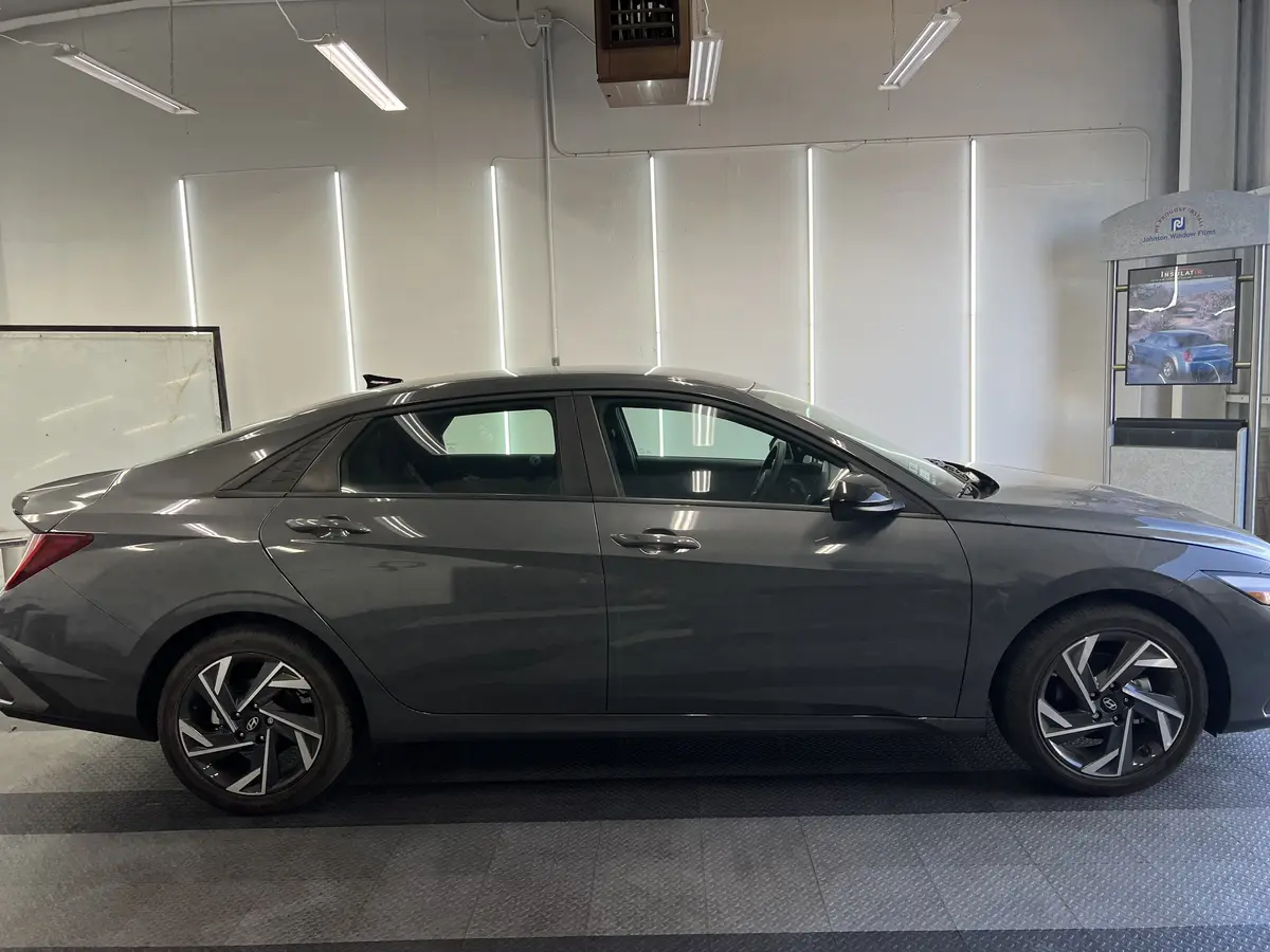 Gray Hyundai Elantra before window tinting, factory glass (view 3)