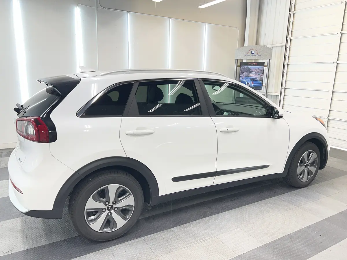 White Kia Niro before window tinting, factory glass (view 3)