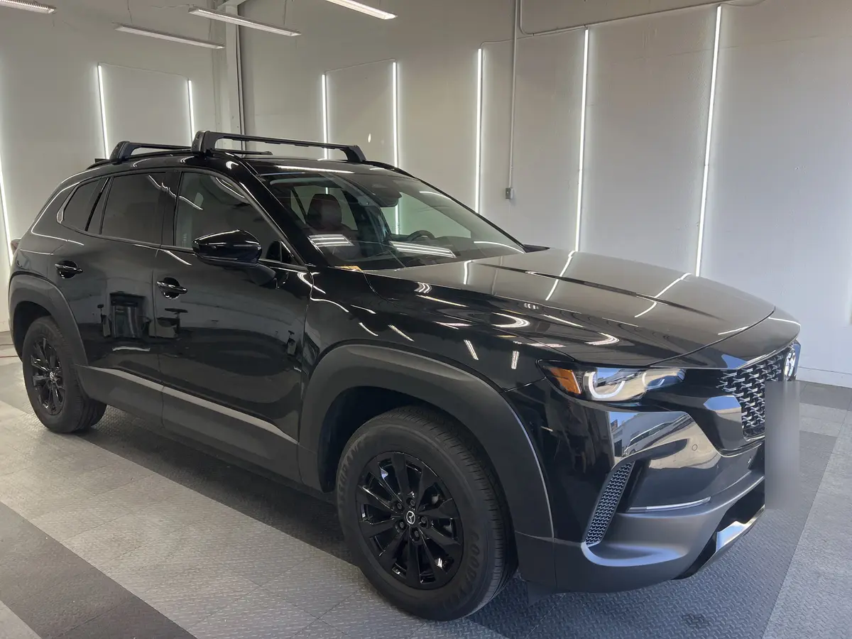Black Mazda CX-50 before window tinting, factory glass (view 1)