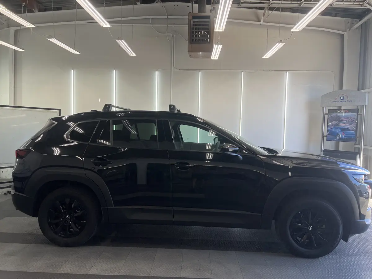 Black Mazda CX-50 before window tinting, factory glass (view 2)