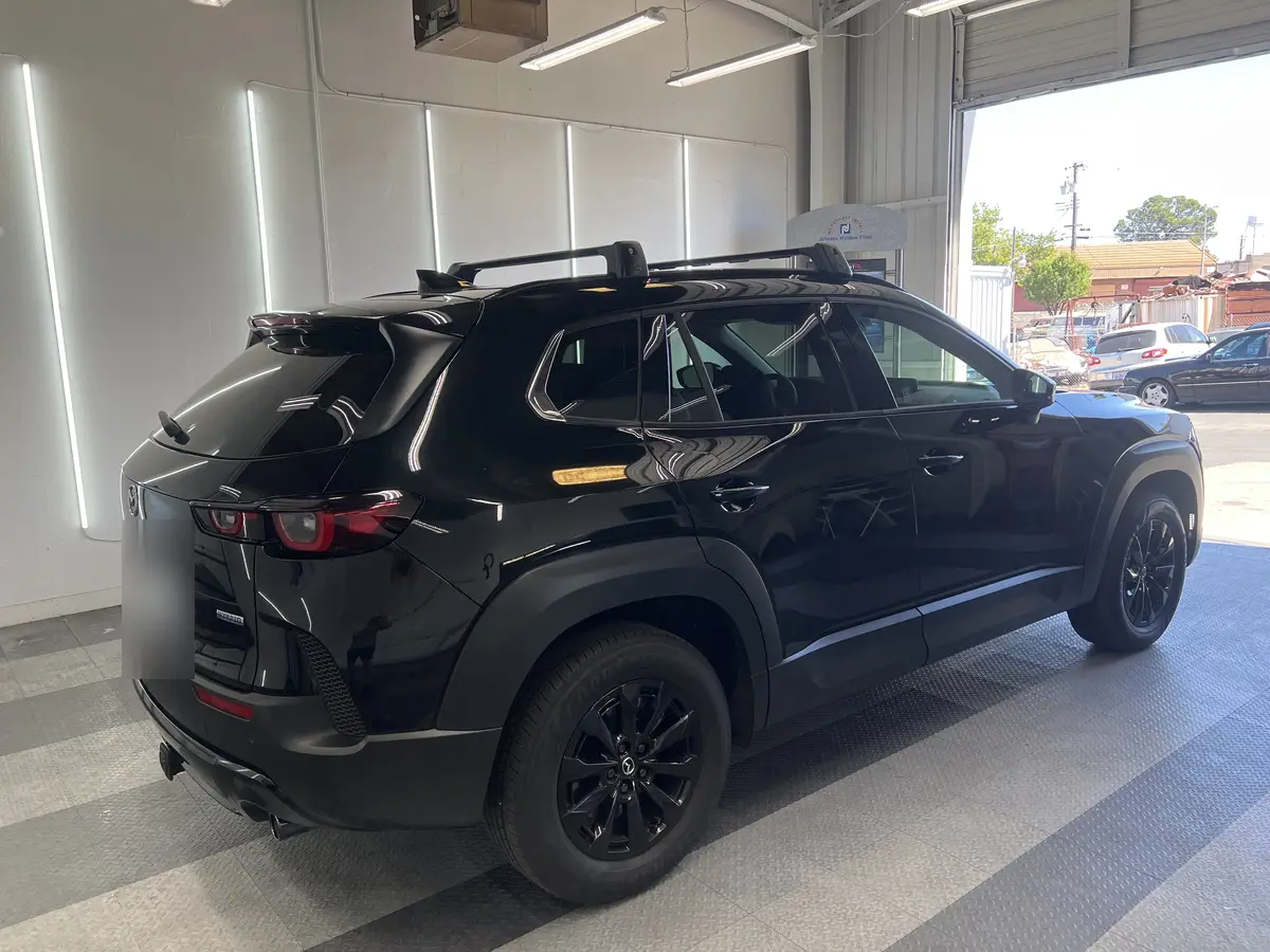 Black Mazda CX-50 before window tinting, factory glass (view 3)