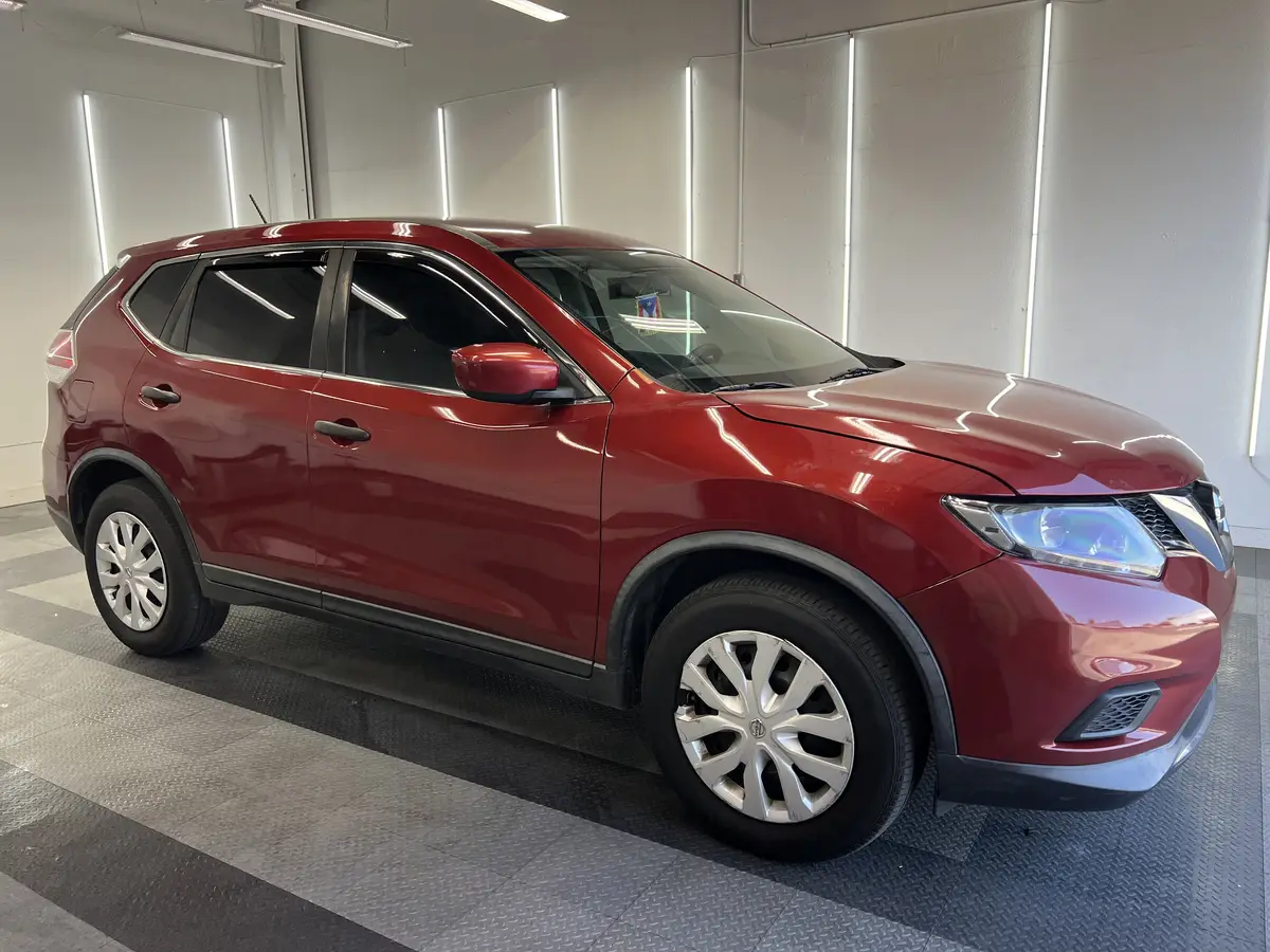 Red Nissan Rogue after Avery Dennison Encore carbon window tint (view 1)