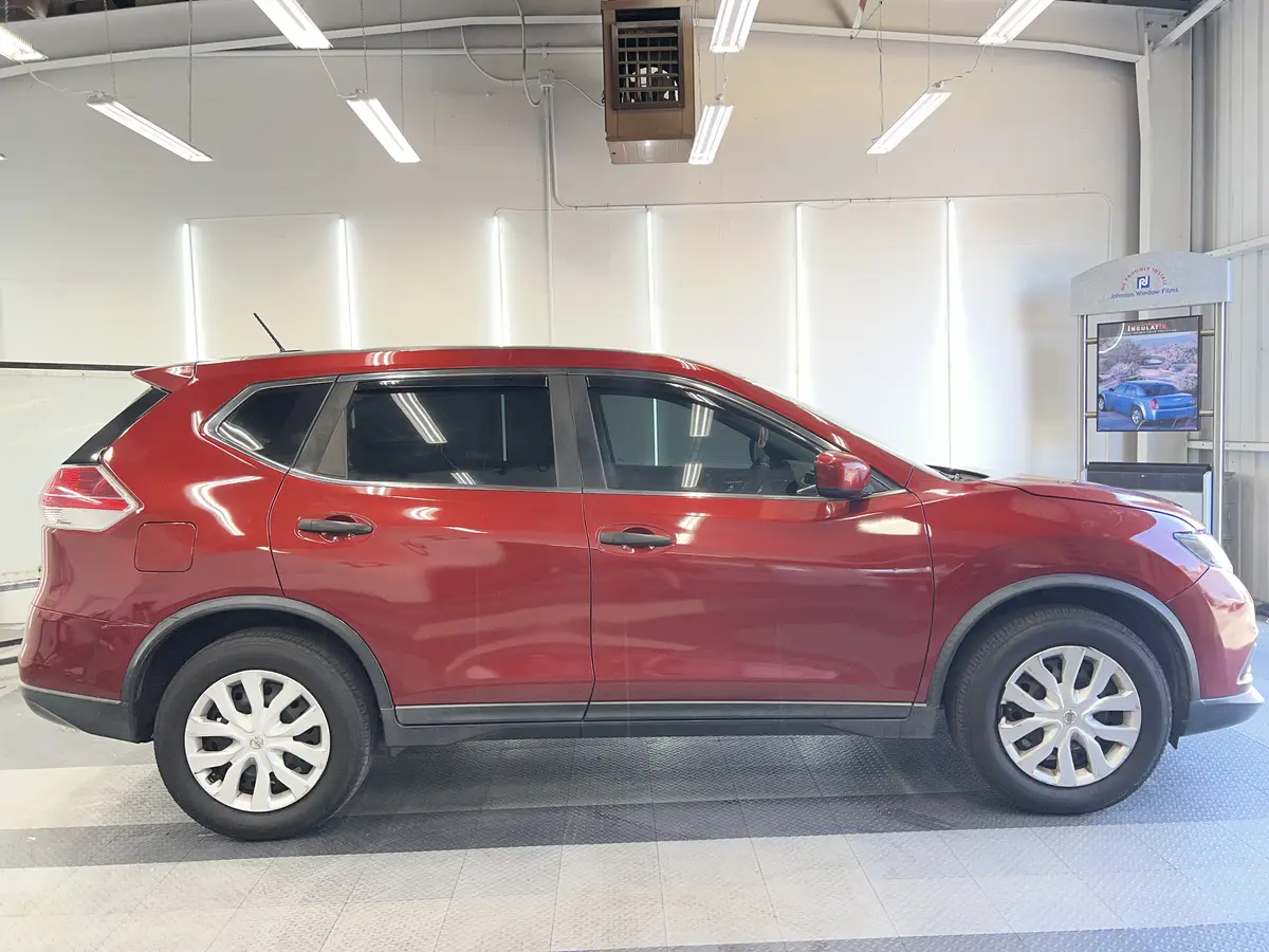 Red Nissan Rogue after Avery Dennison Encore carbon window tint (view 2)