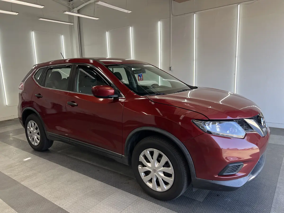 Red Nissan Rogue before window tinting, factory glass (view 1)