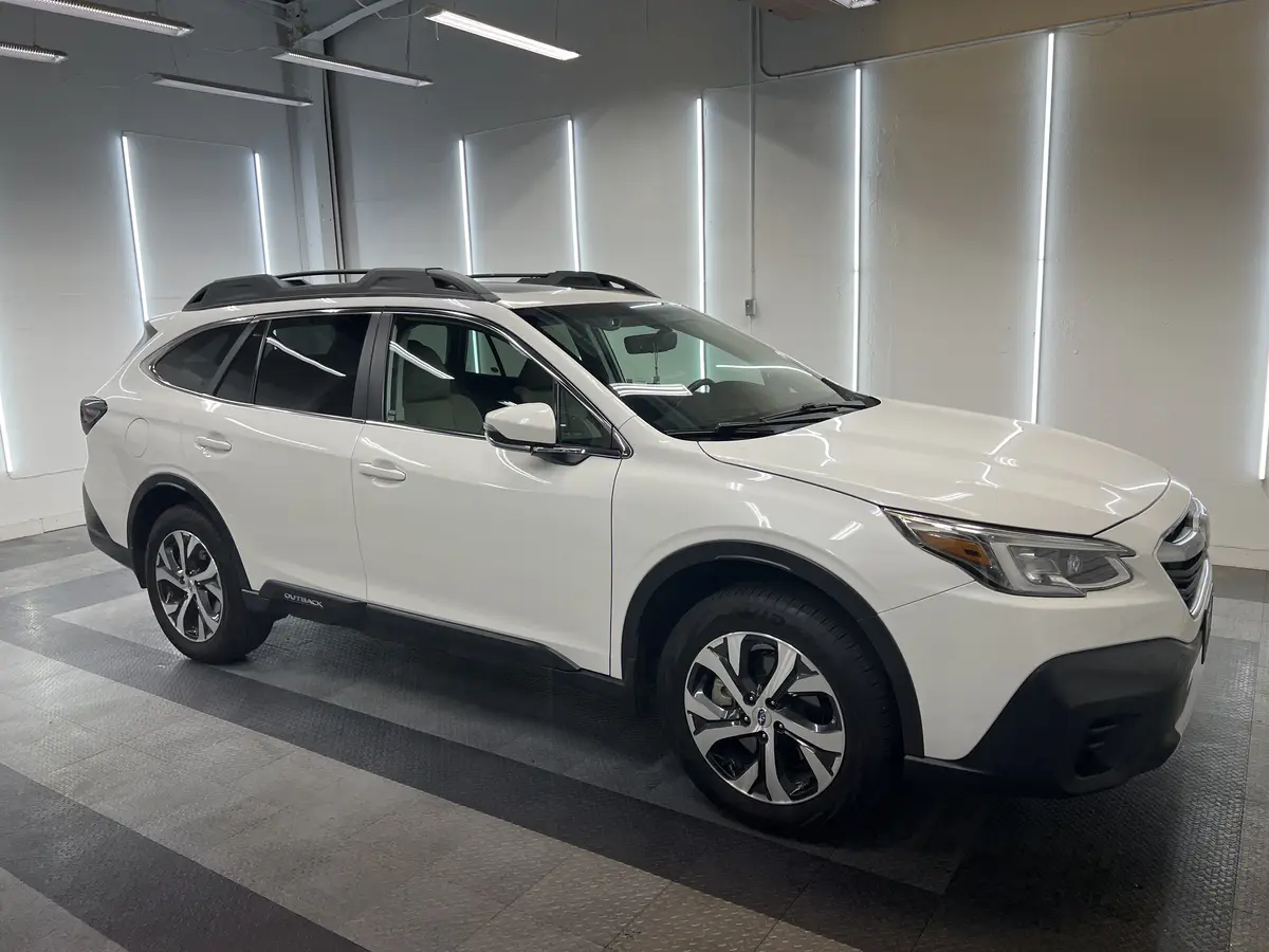 White Subaru Outback before window tinting, factory glass (view 1)