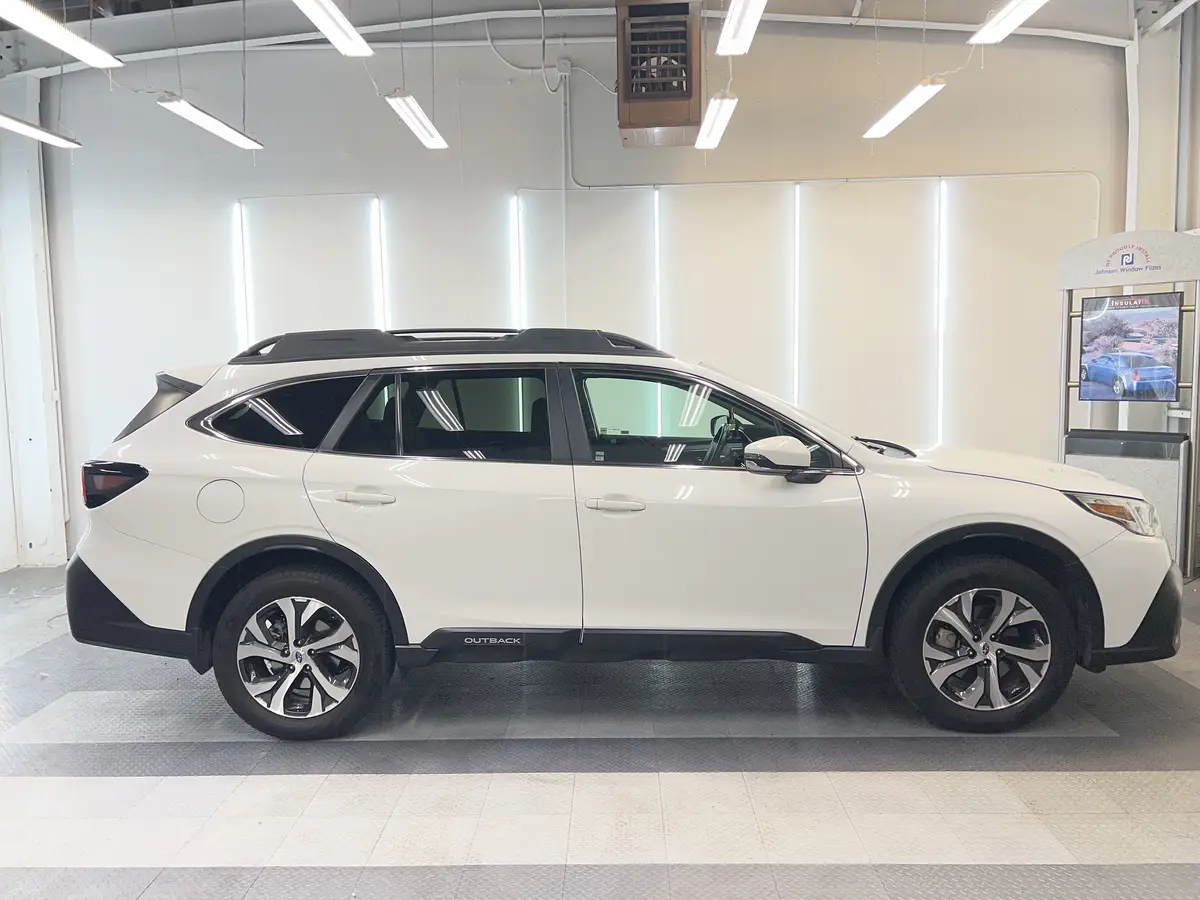 White Subaru Outback before window tinting, factory glass (view 2)