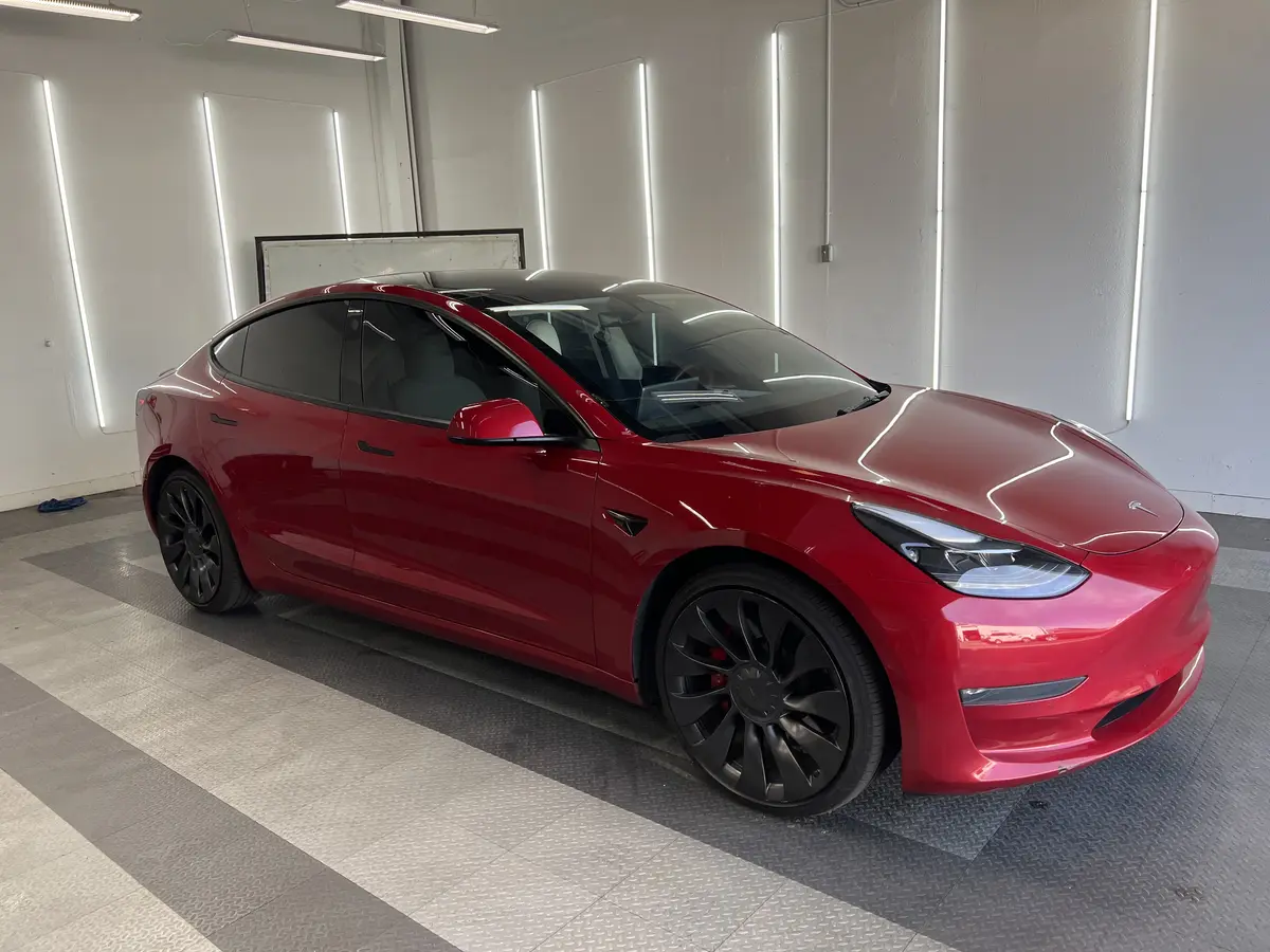 Red Tesla Model 3 after Avery Dennison Encore Supreme ceramic window tint (view 3)