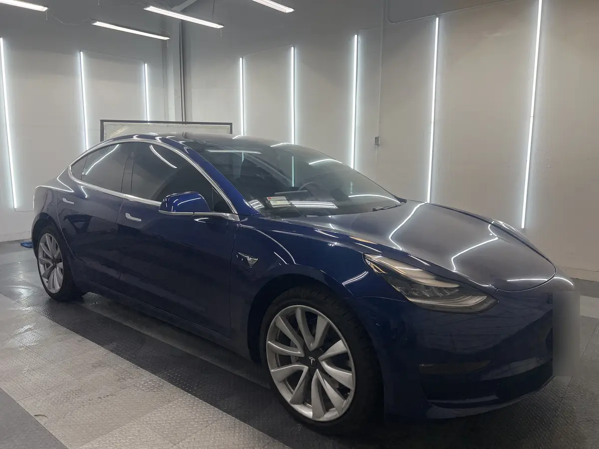 Blue Tesla Model 3 after Avery Dennison Encore carbon window tint (view 1)