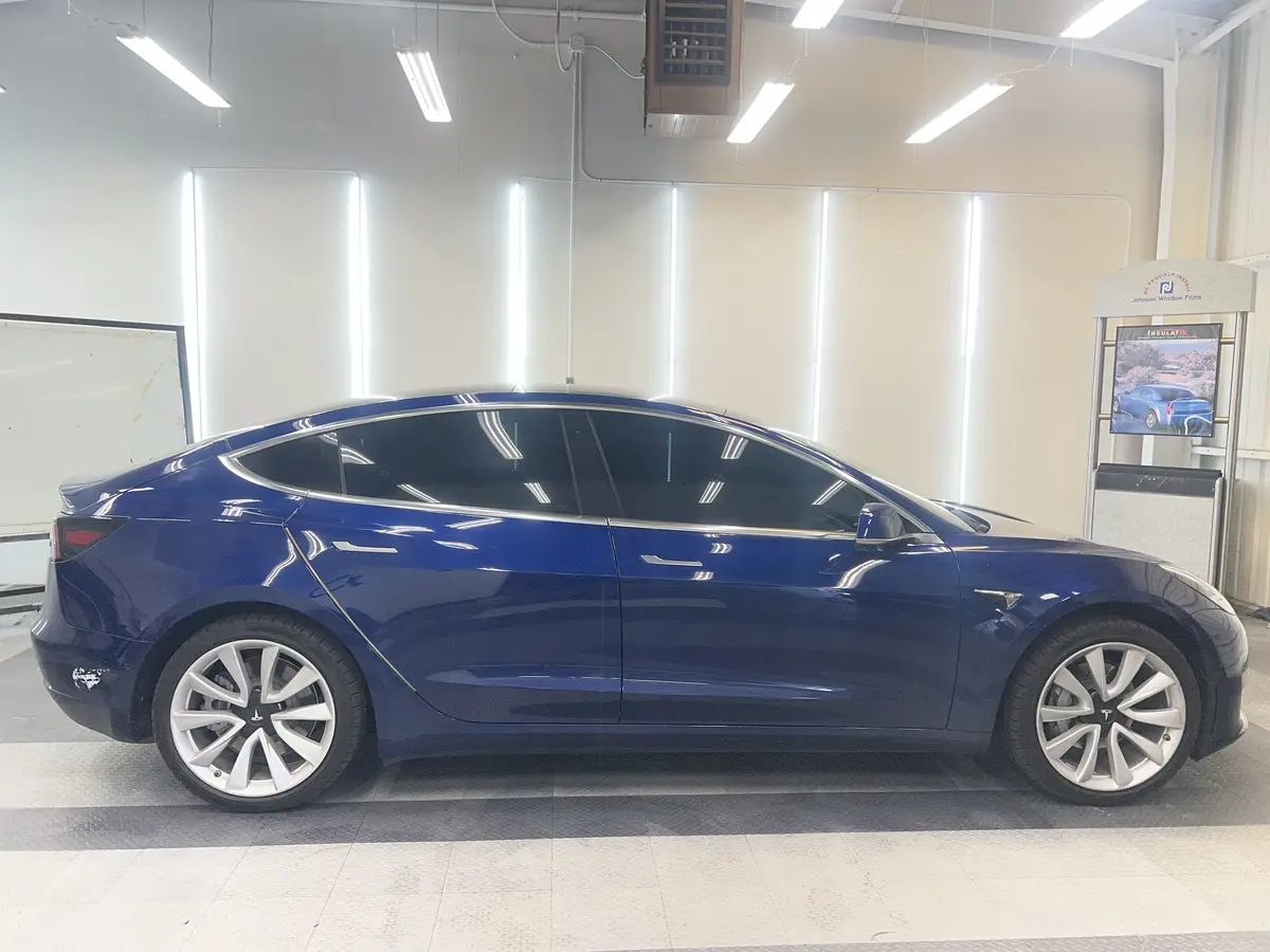 Blue Tesla Model 3 after Avery Dennison Encore carbon window tint (view 2)