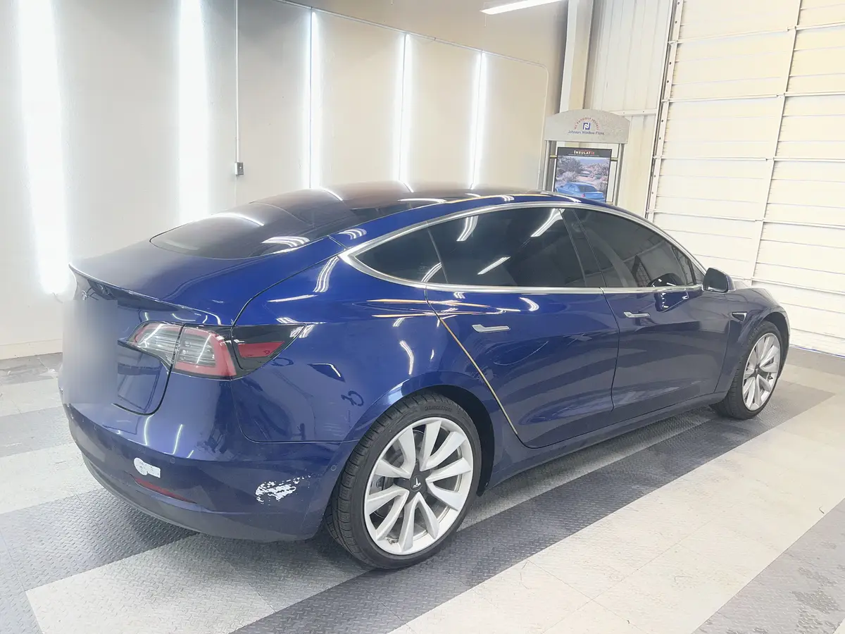 Blue Tesla Model 3 after Avery Dennison Encore carbon window tint (view 3)