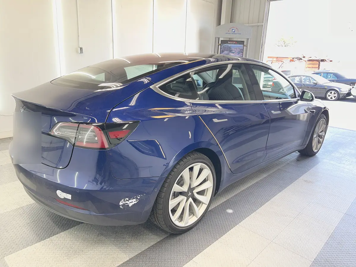 Blue Tesla Model 3 before window tinting, factory glass (view 1)