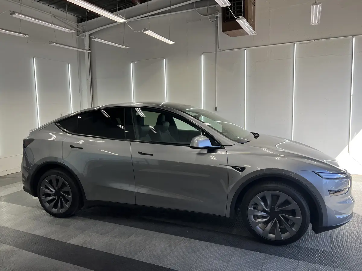 Gray Tesla Model Y before window tinting, factory glass (view 1)