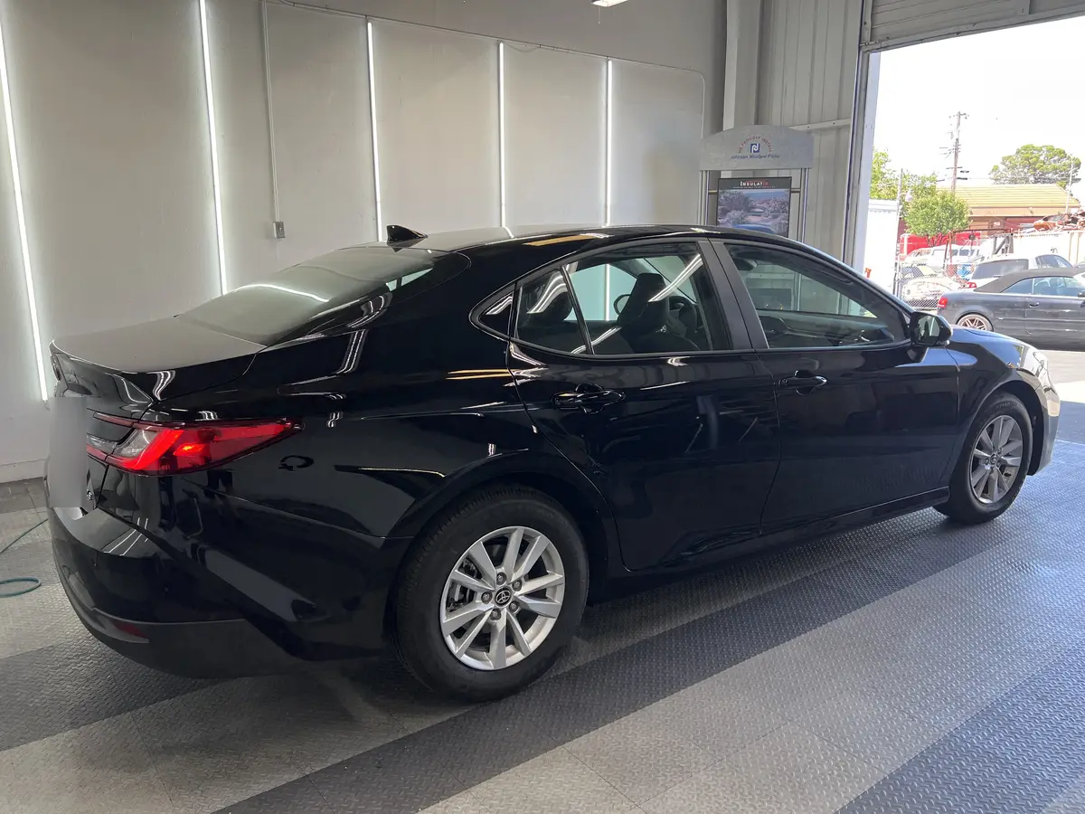 Black Toyota Camry before window tinting, factory glass (view 1)