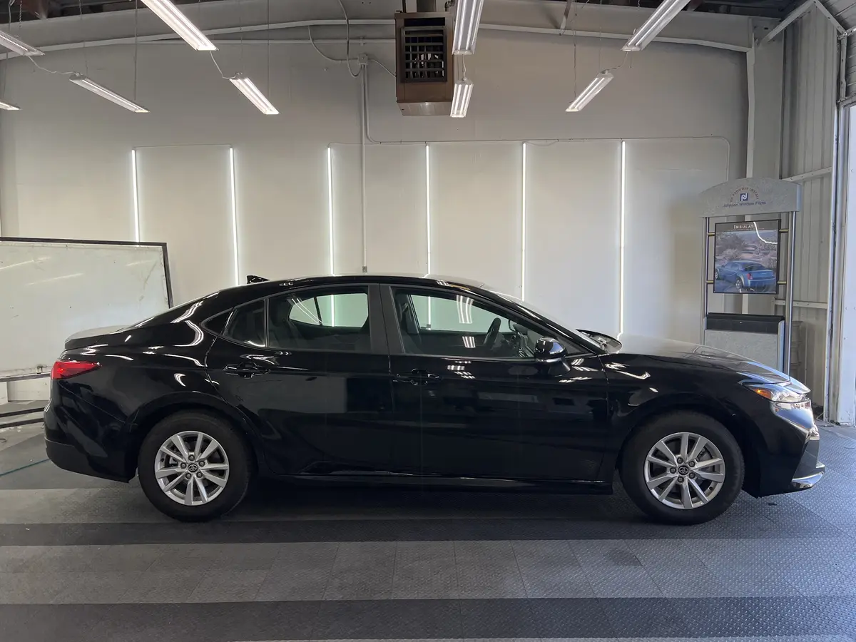 Black Toyota Camry before window tinting, factory glass (view 2)