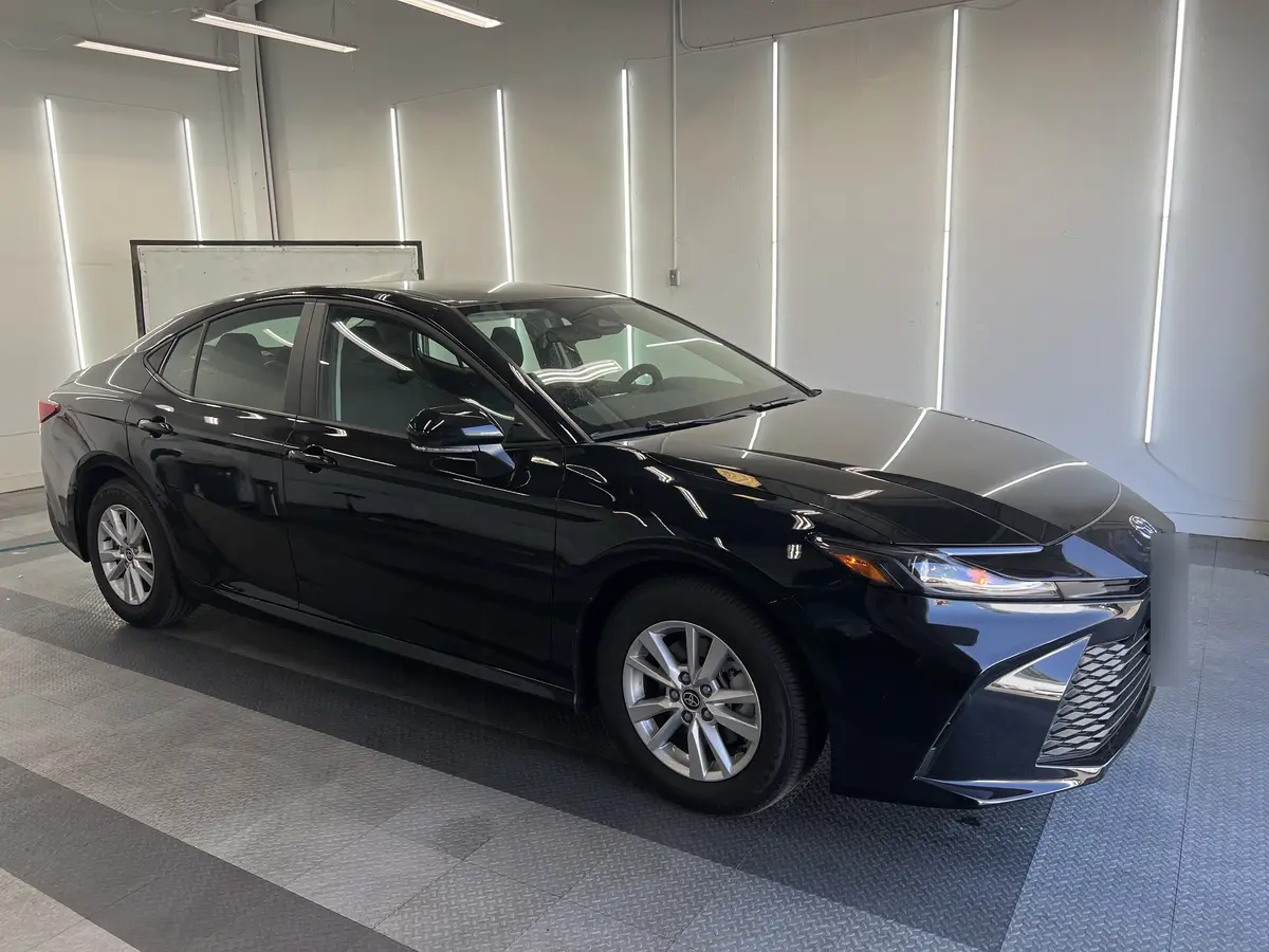 Black Toyota Camry before window tinting, factory glass (view 3)