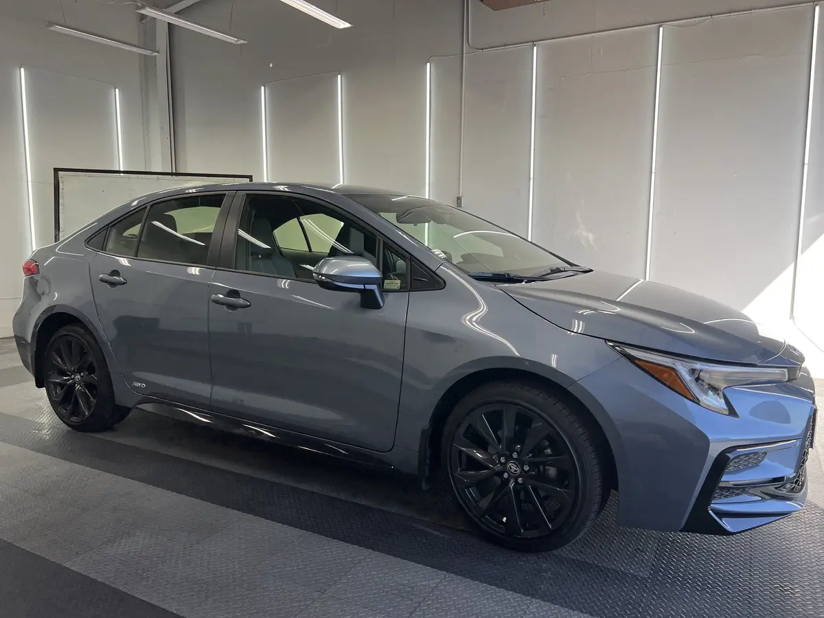 Gray Toyota Corolla before window tinting, factory glass (view 1)