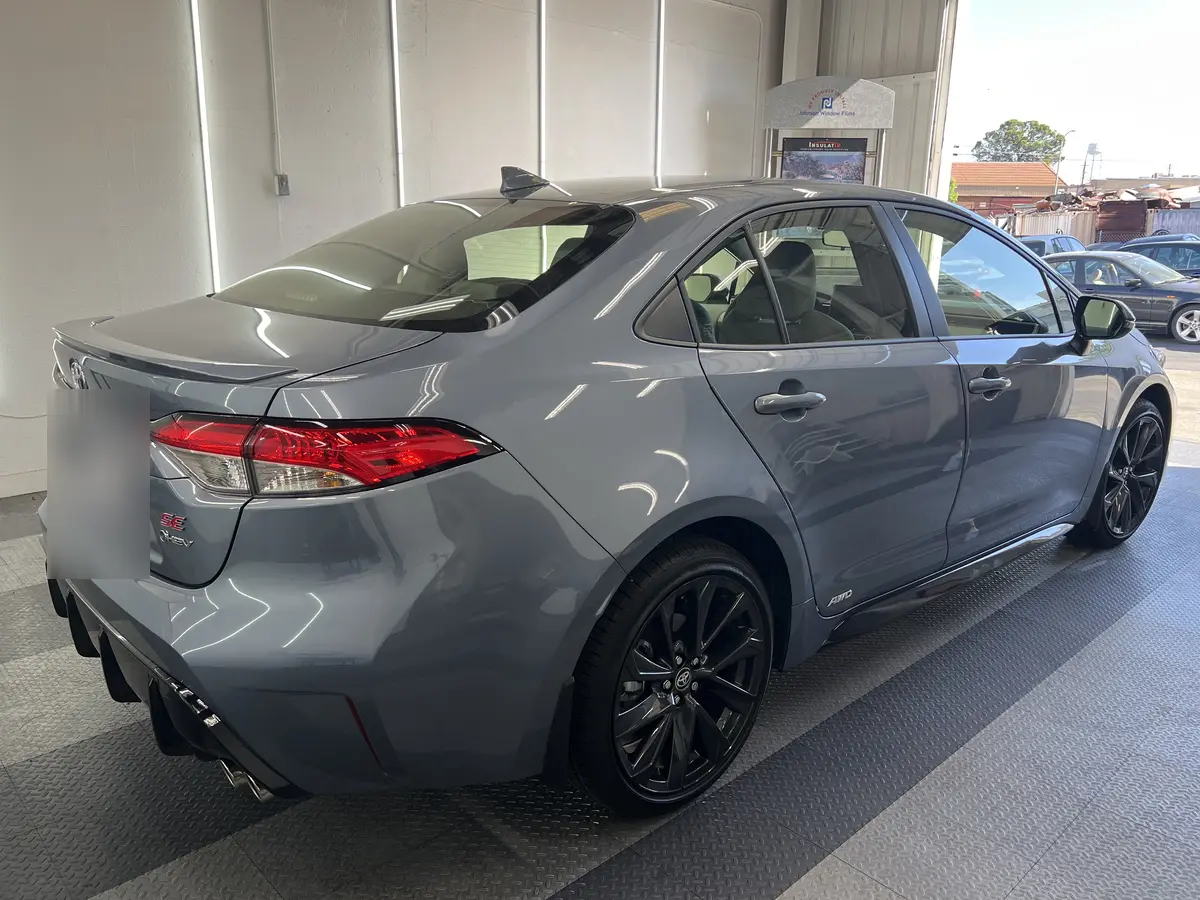 Gray Toyota Corolla before window tinting, factory glass (view 3)