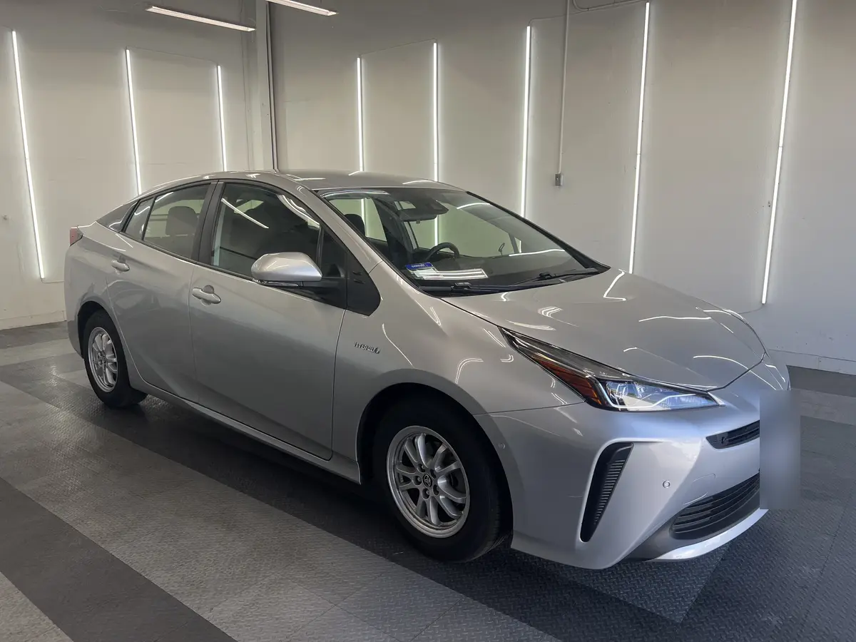 Silver Toyota Prius before window tinting, factory glass (view 2)