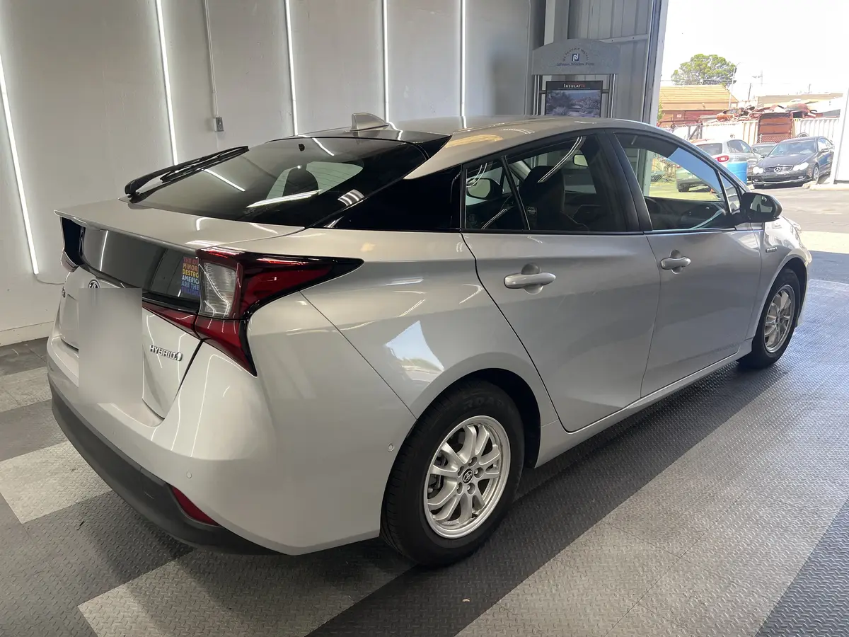Silver Toyota Prius before window tinting, factory glass (view 3)