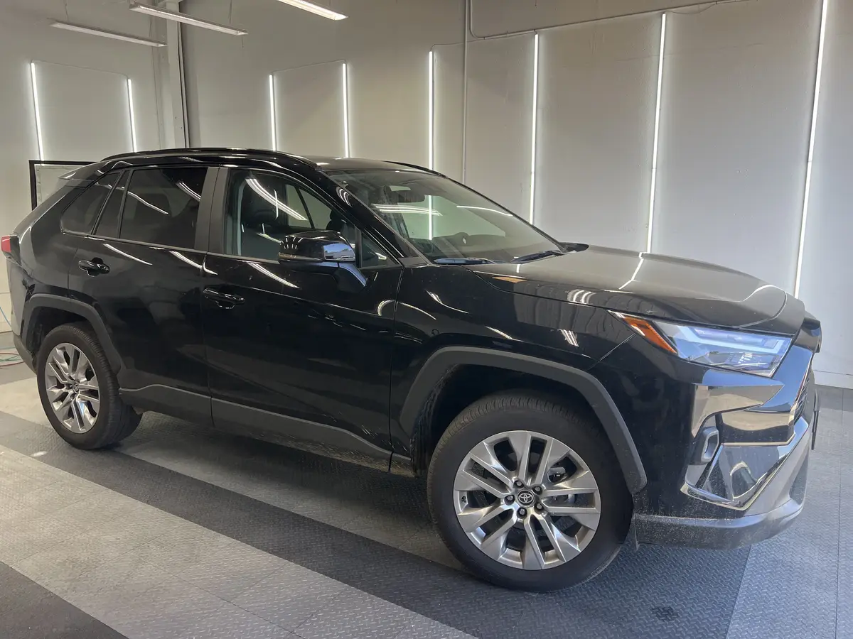 Black Toyota RAV4 before window tinting, factory glass (view 1)