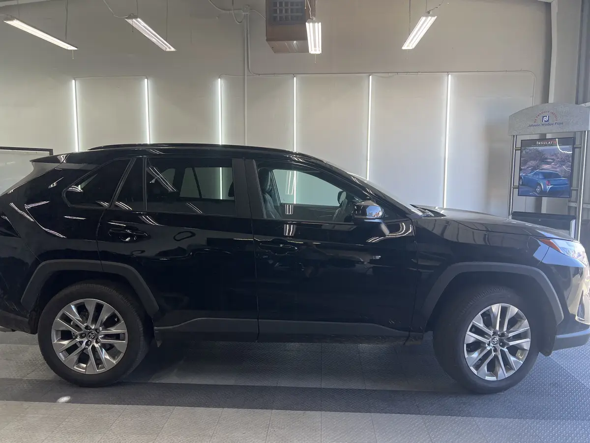 Black Toyota RAV4 before window tinting, factory glass (view 3)