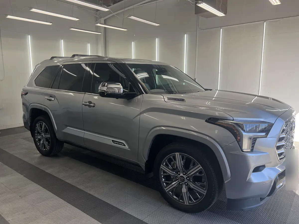 Silver Toyota Sequoia before window tinting, factory glass (view 1)