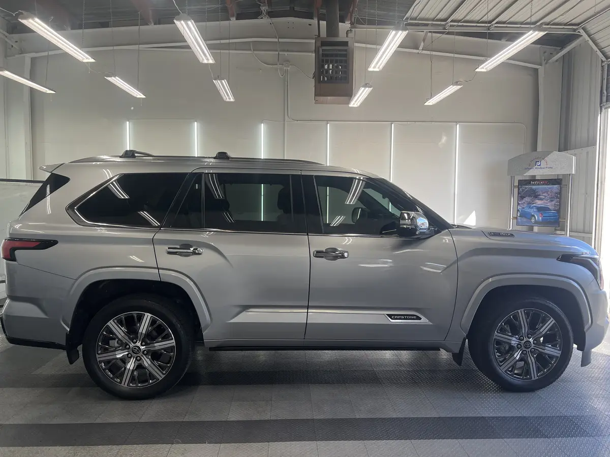 Silver Toyota Sequoia before window tinting, factory glass (view 2)