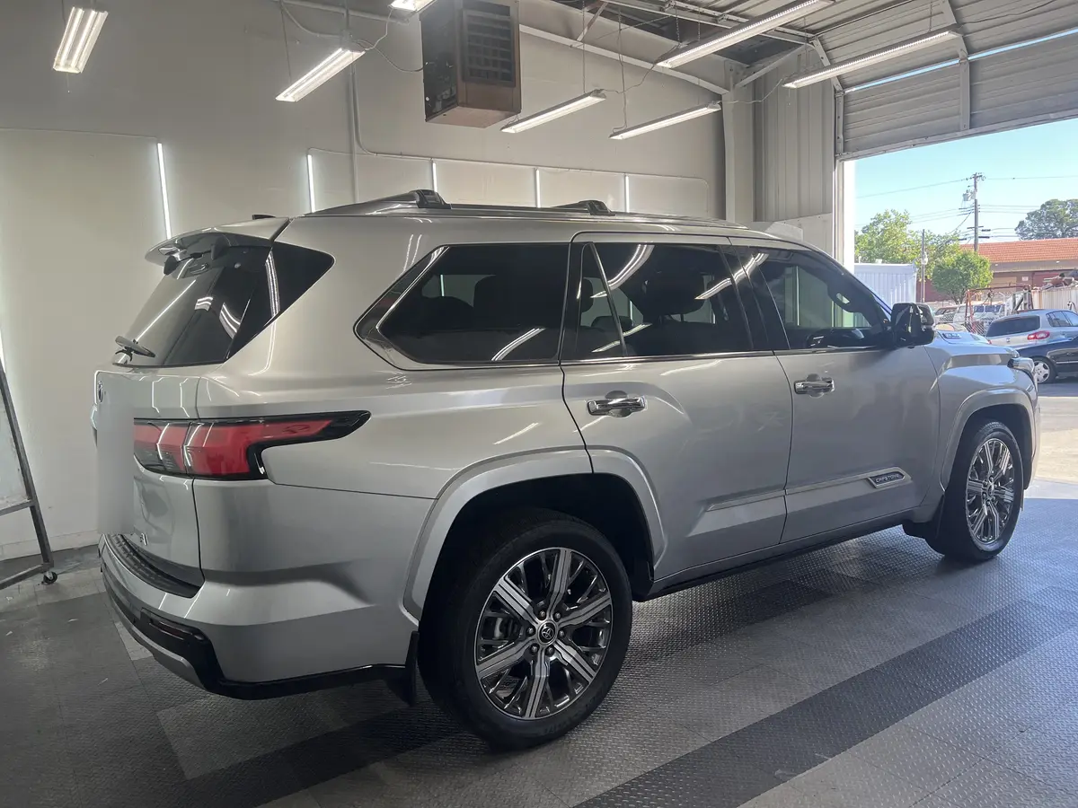 Silver Toyota Sequoia before window tinting, factory glass (view 3)