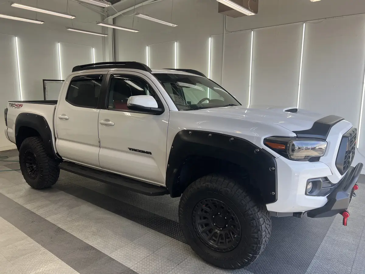 White Toyota Tacoma before window tinting, factory glass (view 3)