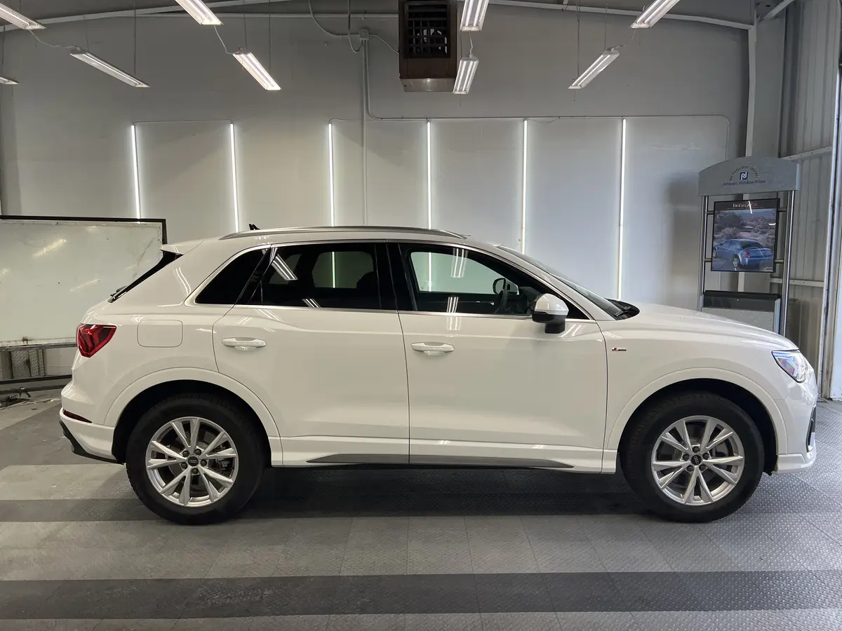 White Audi Q3 before window tinting, factory glass (view 2)