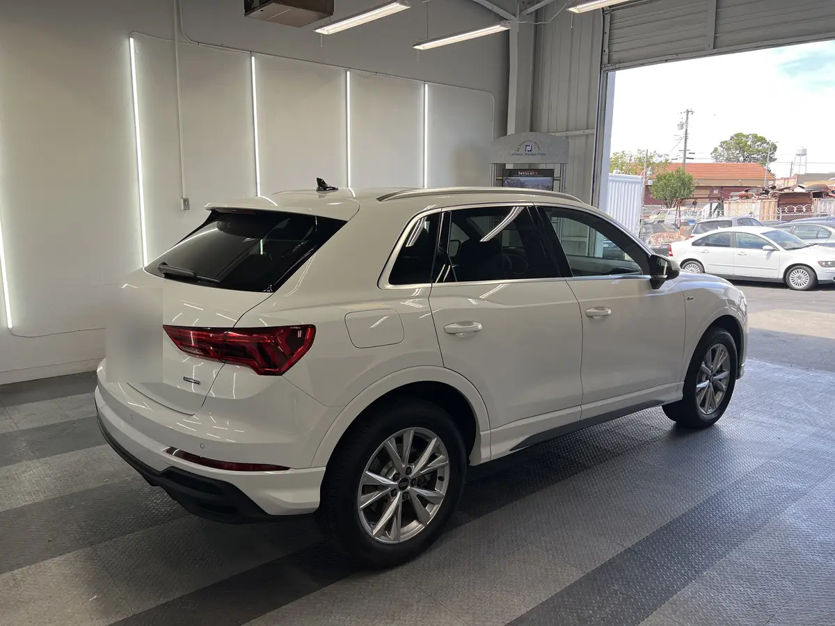 White Audi Q3 before window tinting, factory glass (view 3)
