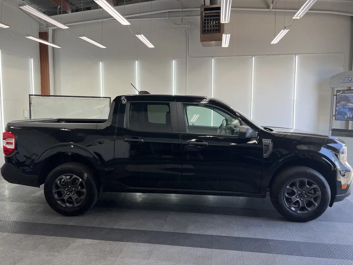 Black Ford Maverick before window tinting, factory glass (view 1)