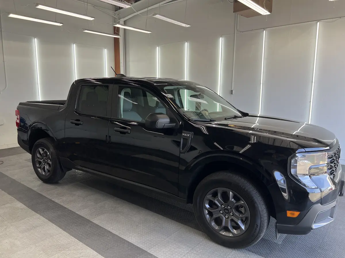 Black Ford Maverick before window tinting, factory glass (view 2)