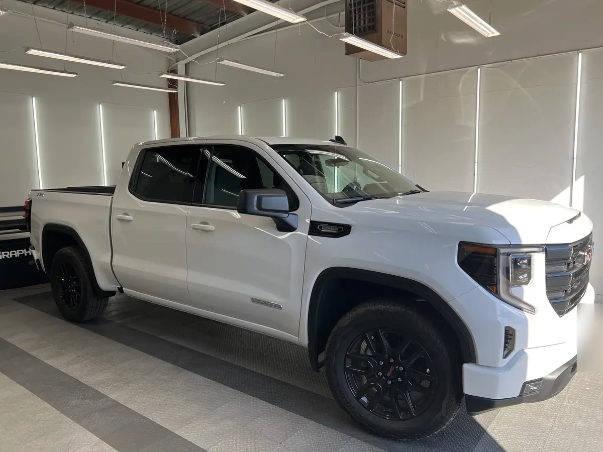 White GMC Sierra 1500 before window tinting, factory glass (view 1)