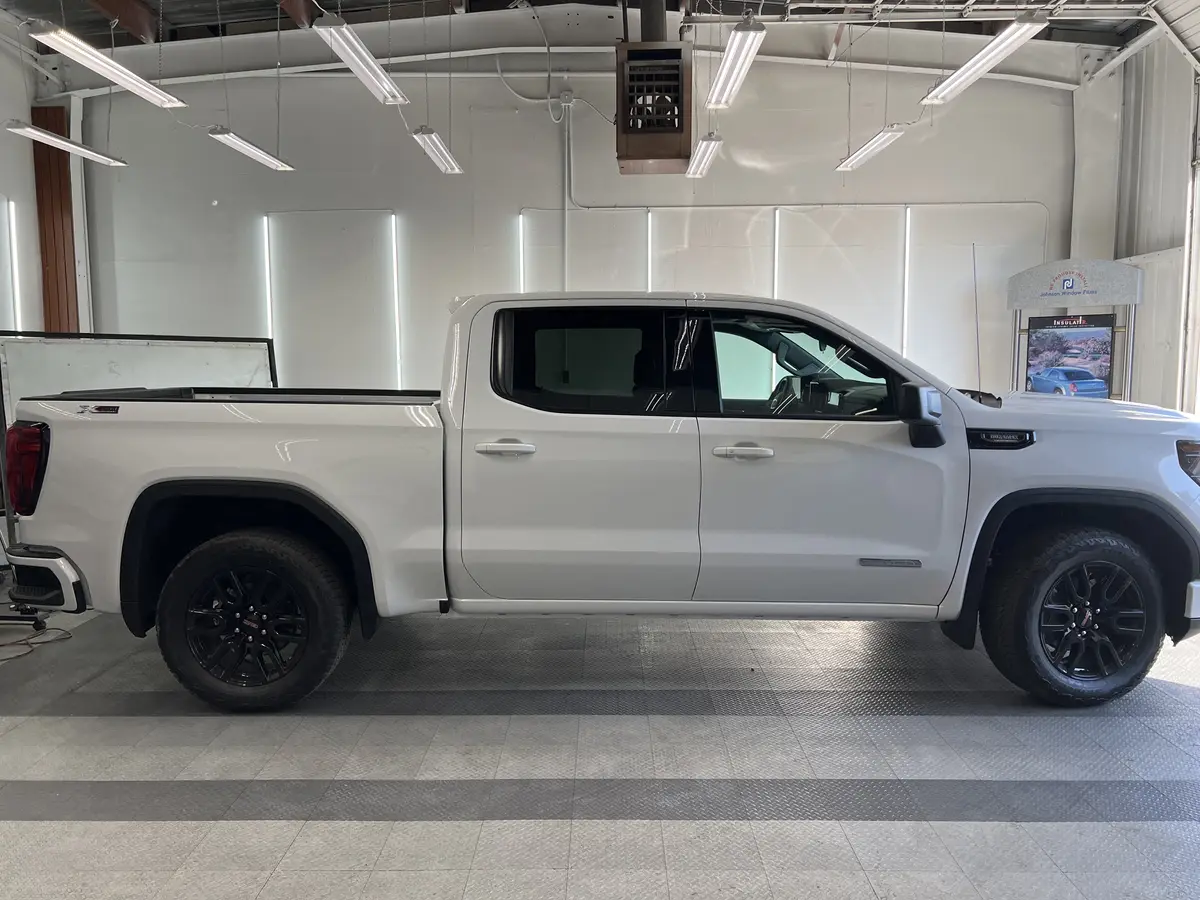 White GMC Sierra 1500 before window tinting, factory glass (view 2)