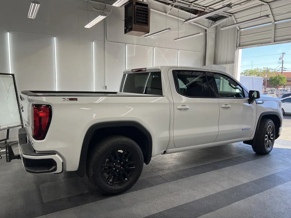 White GMC Sierra 1500 before window tinting, factory glass (view 3)