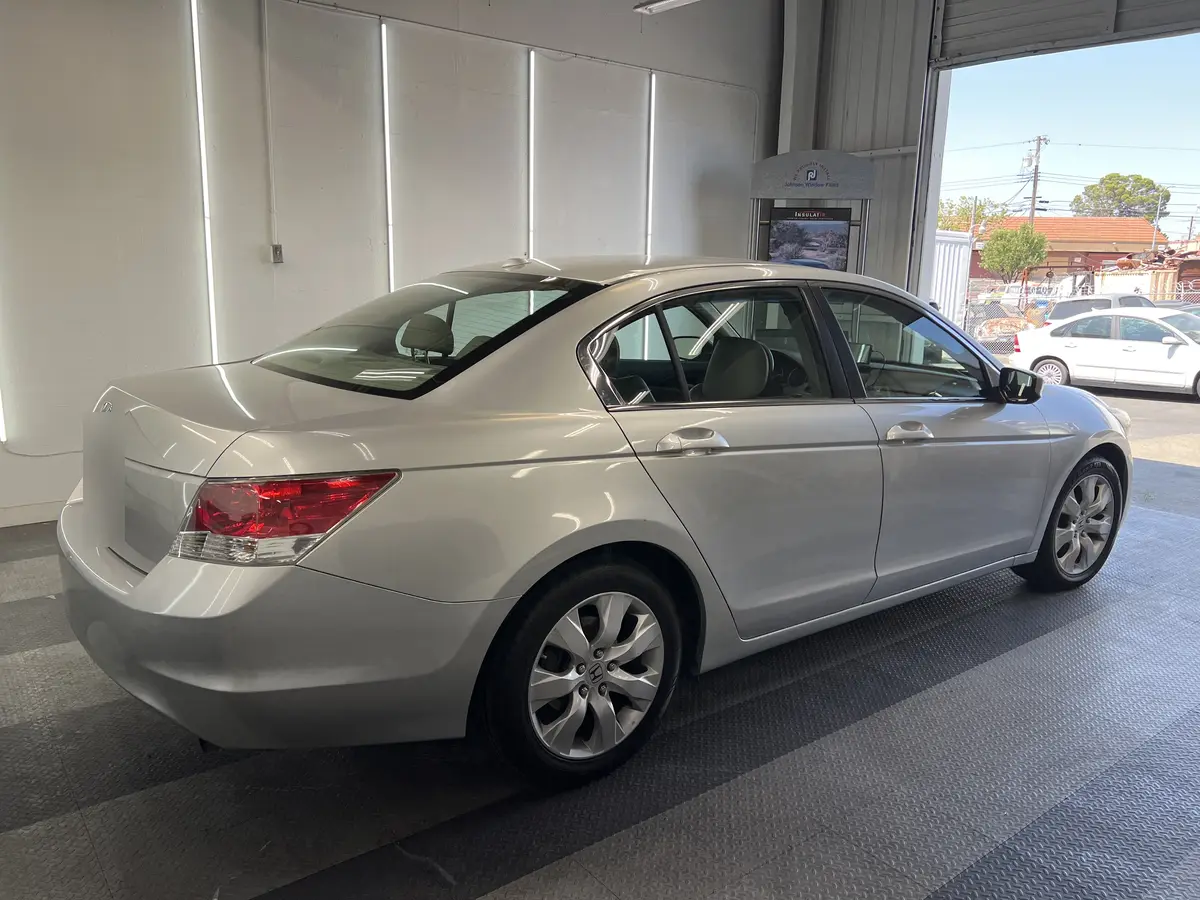 Silver Honda Accord before window tinting, factory glass (view 1)