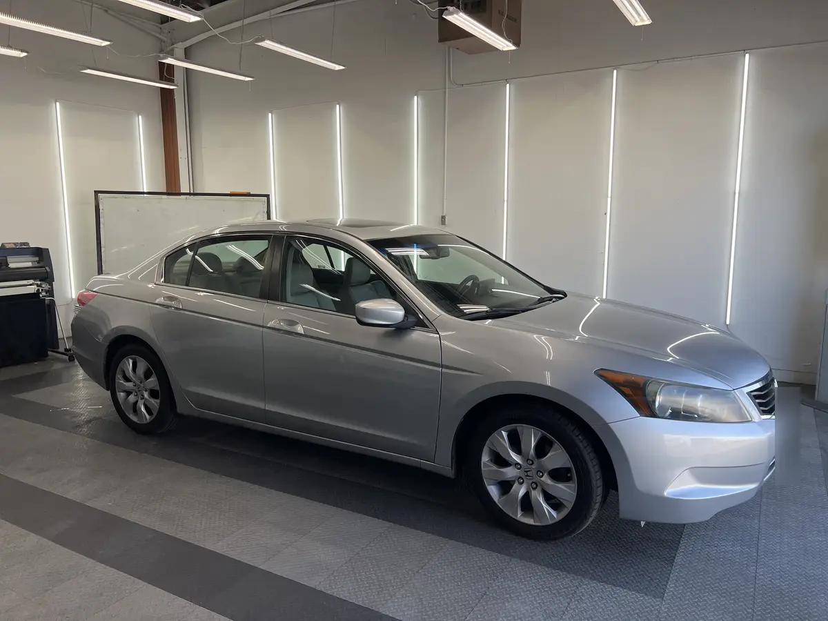 Silver Honda Accord before window tinting, factory glass (view 3)
