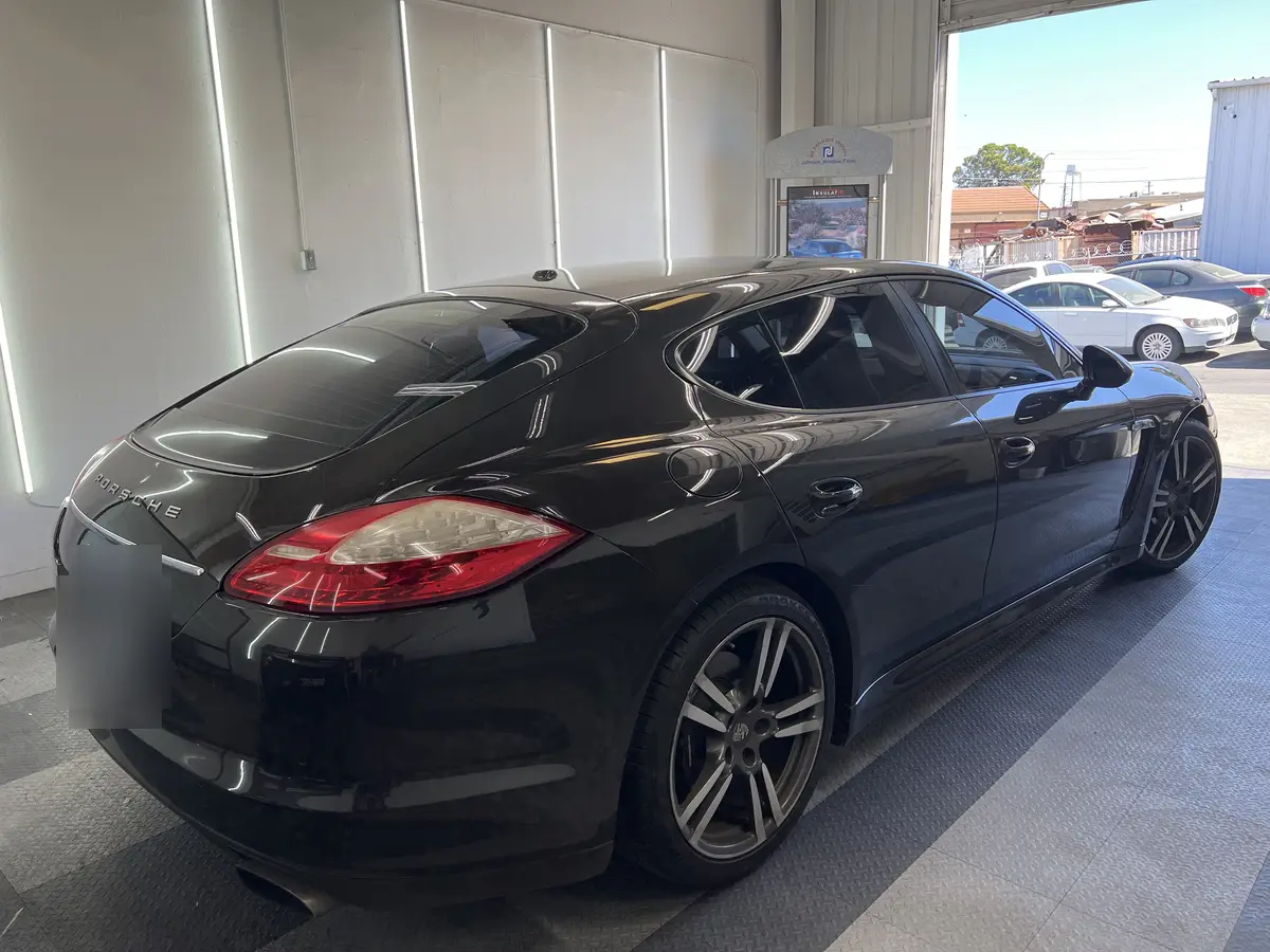Black Porsche Panamera before window tinting, factory glass (view 1)