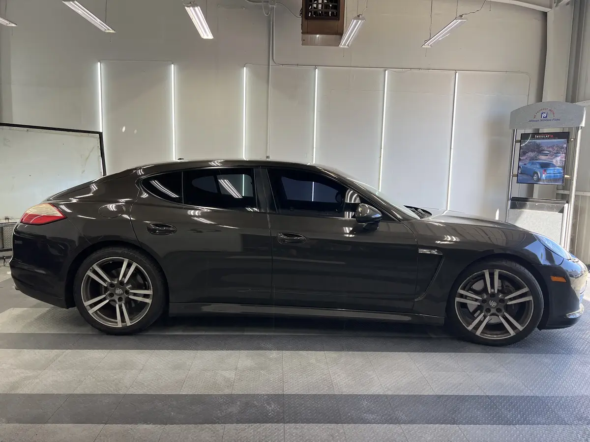 Black Porsche Panamera before window tinting, factory glass (view 2)